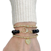 Love Lisa heart charm beaded bracelet worn on wrist layered with stretch bracelets