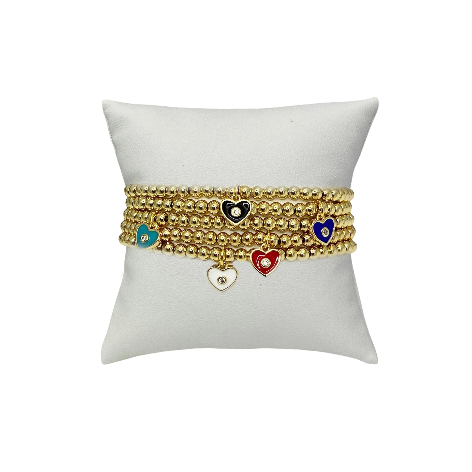 mini evil eye heart charm bracelet displayed for gifting gold beaded jewelry