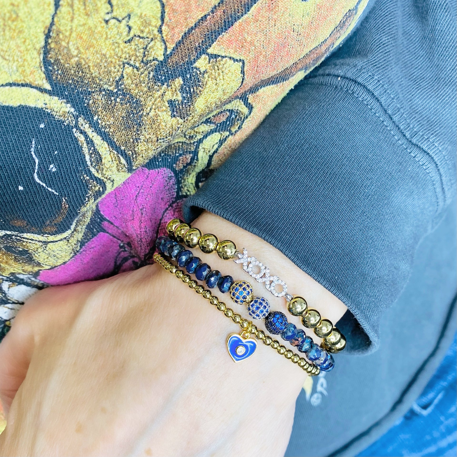 Love Lisa evil eye heart bracelets stacked on wrist gold beaded charm jewelry