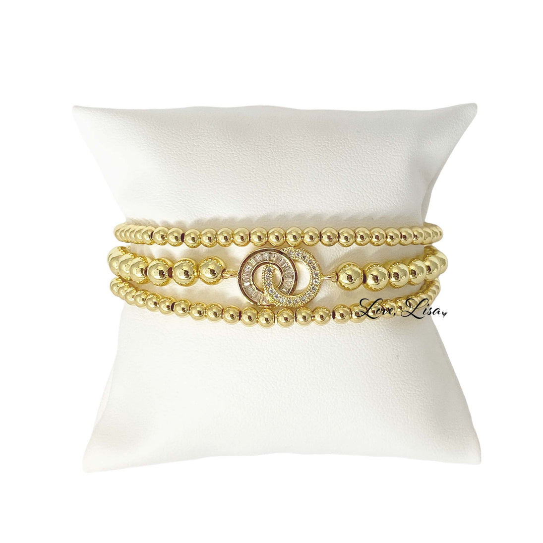 Love Lisa Together Forever three stack bracelet set in gold featuring crystal and baguette accented beaded bracelets layered on wrist